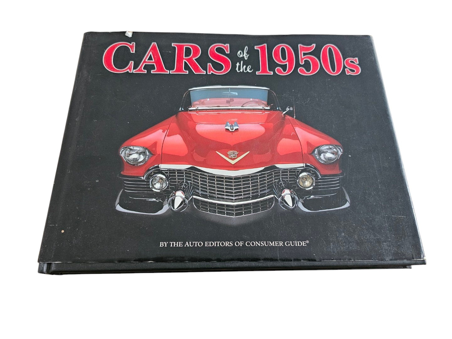 Automoto Bookshop Cars of the 1950's hardcover book featuring a red vintage Cadillac on the black cover.