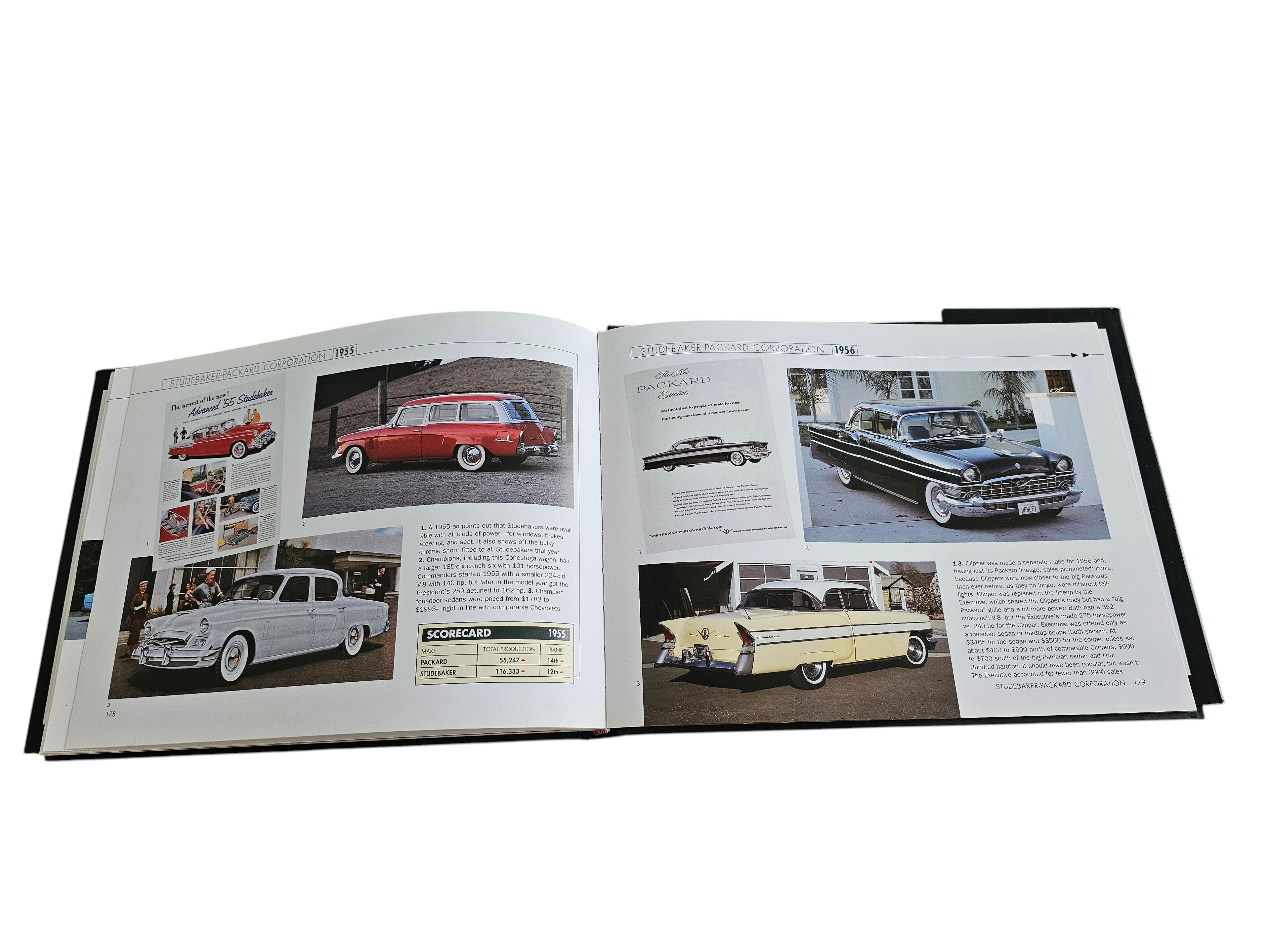 Automoto Bookshop Cars of the 1950's hardcover book open to pages featuring vintage Studebaker and Packard car photos.