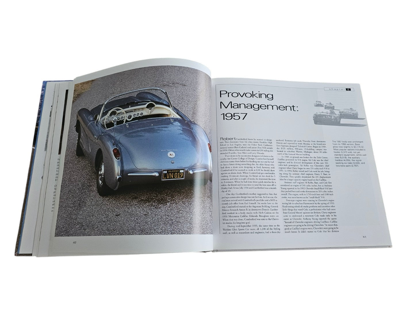 Automoto Bookshop hardcover book open to a page featuring a blue 1957 Corvette convertible and historical text.