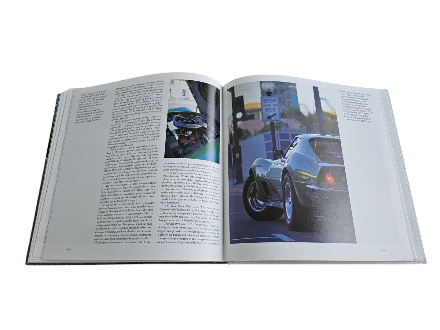 Automoto Bookshop hardcover Corvette book open to a page featuring a classic Sting Ray and historical text