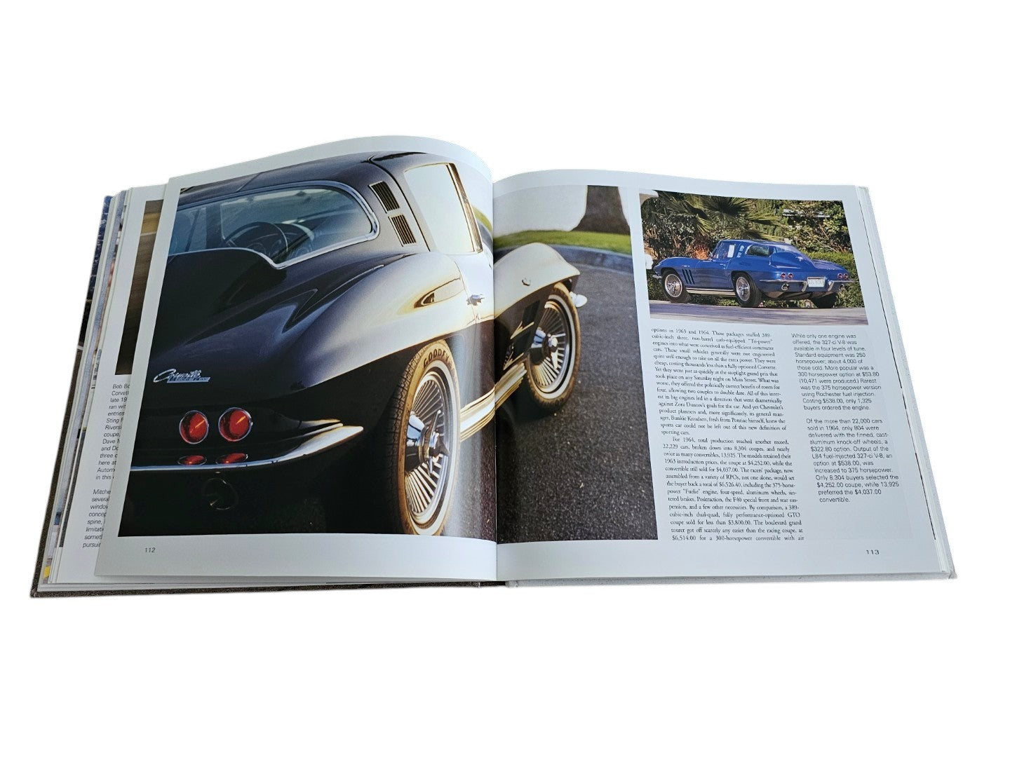 Automoto Bookshop hardcover book open to pages featuring a black vintage Corvette Sting Ray and historical text.