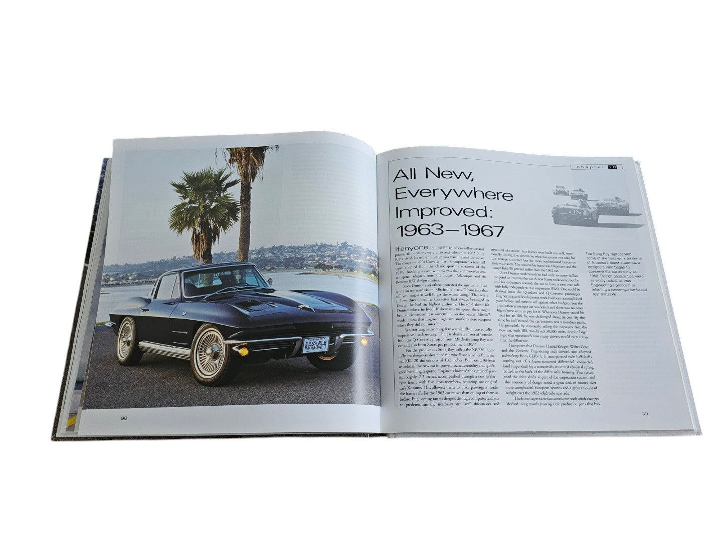 Automoto Bookshop hardcover book open to a page featuring a vintage black Corvette Sting Ray and historical text.