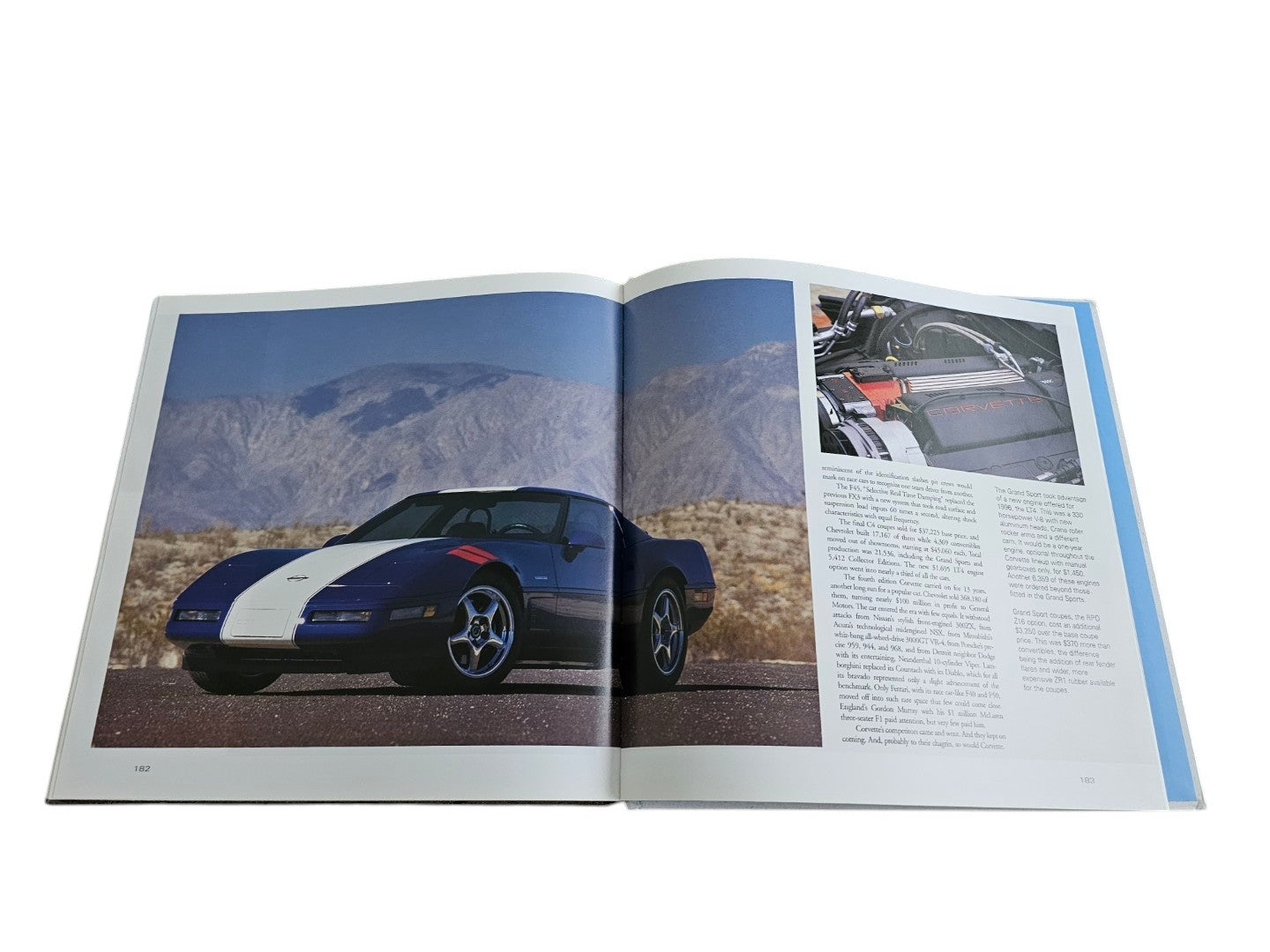 Automoto Bookshop hardcover book open to a page featuring a blue Corvette sports car and engine photography.