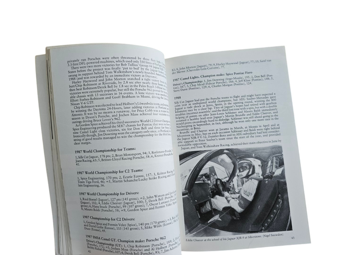 Automoto Bookshop paperback page showing text and a black and white photo of Eddie Cheever in a Jaguar XJR-9 cockpit