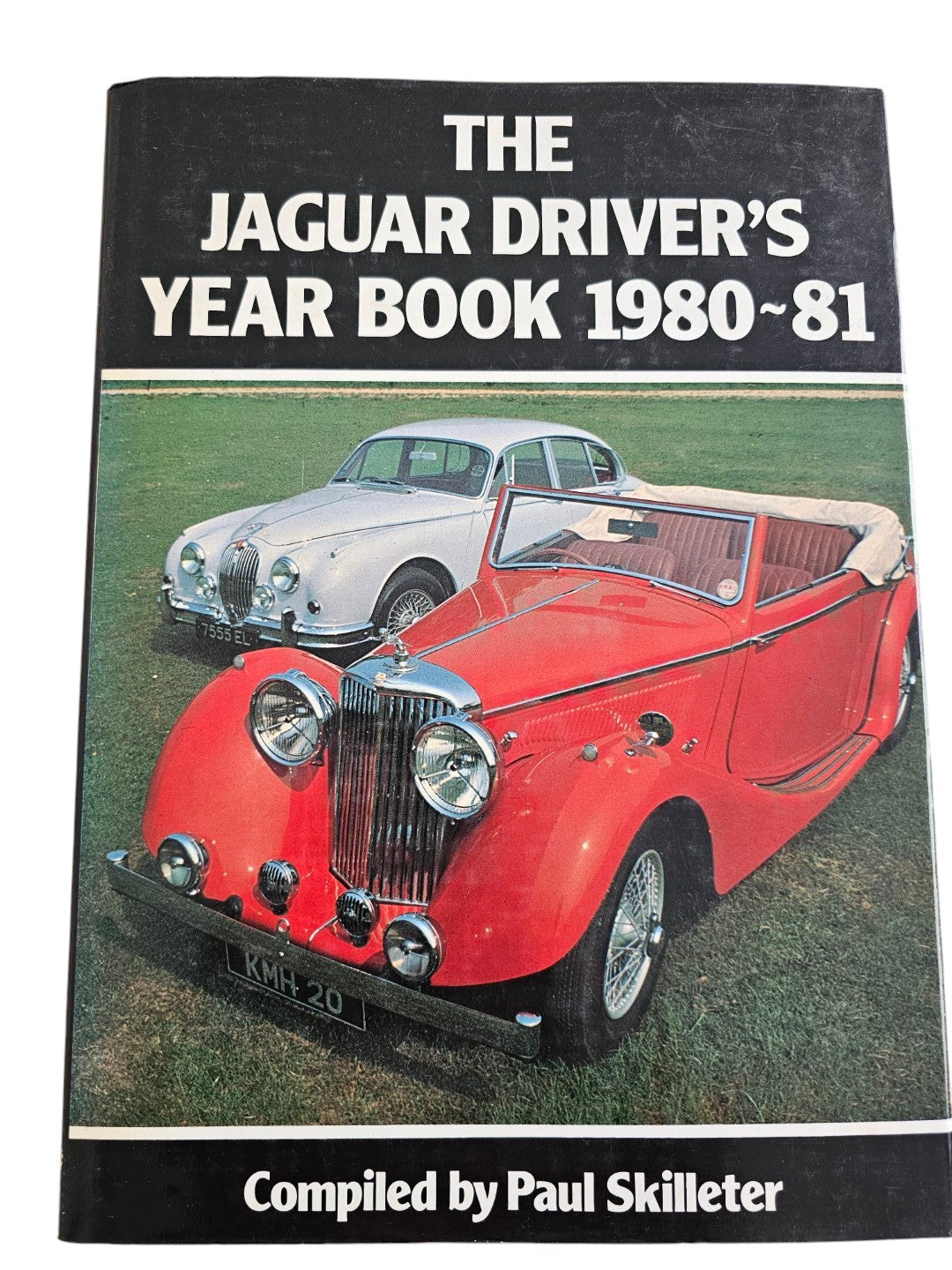 Jaguar year book cover with title text and red classic Jaguar front view