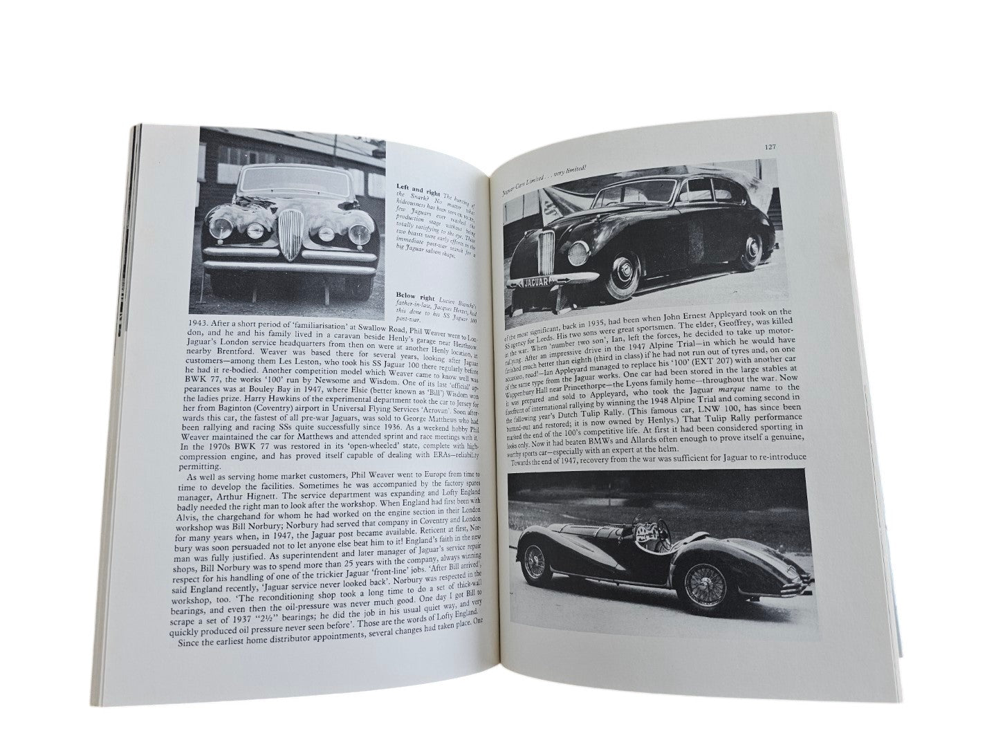 Automoto Bookshop Jaguar The Definitive History book open to page 127 showing vintage black and white car photographs