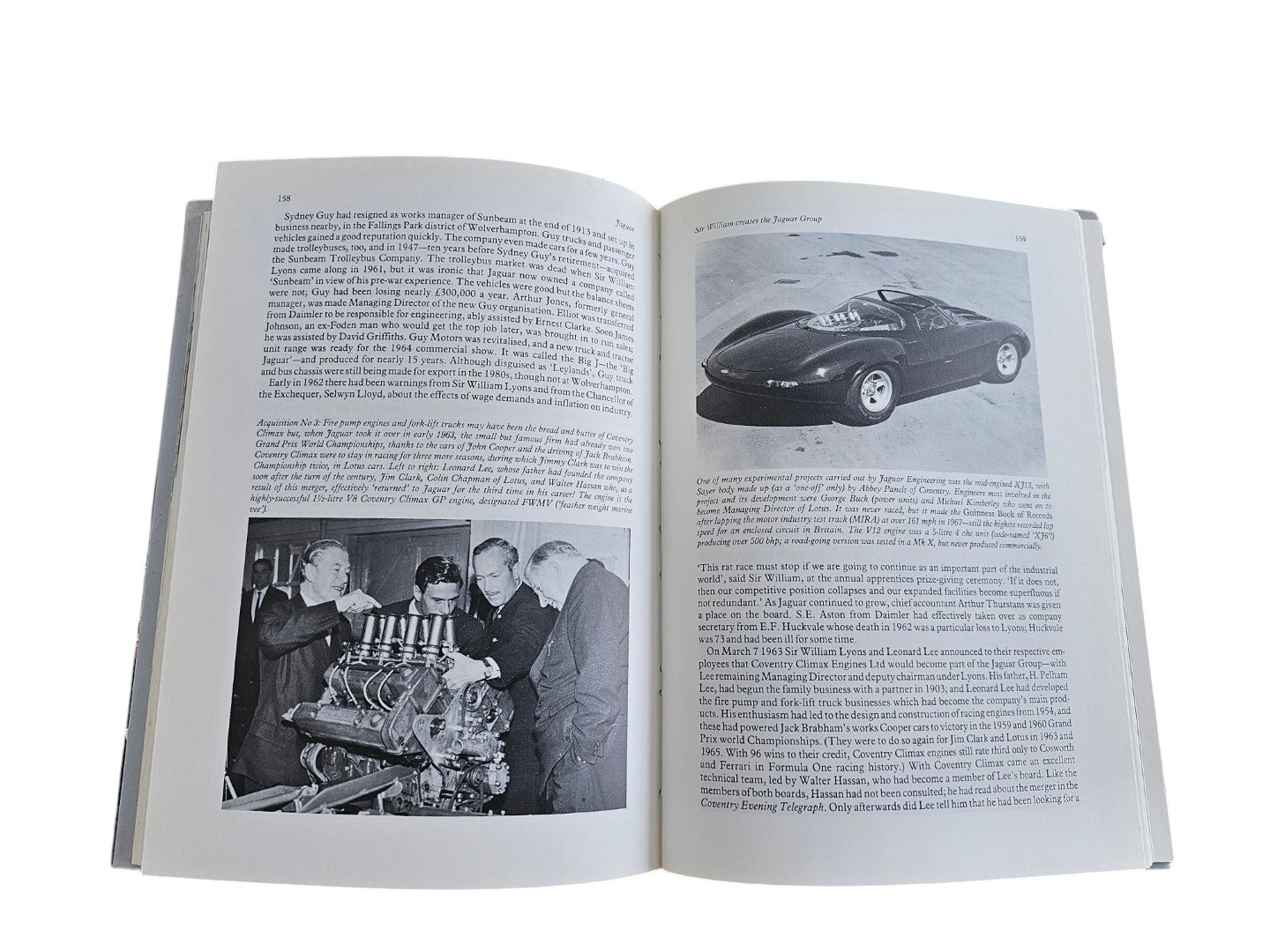 Open pages of Automoto Bookshop Jaguar The Definitive History book showing vintage car photos and historical text.