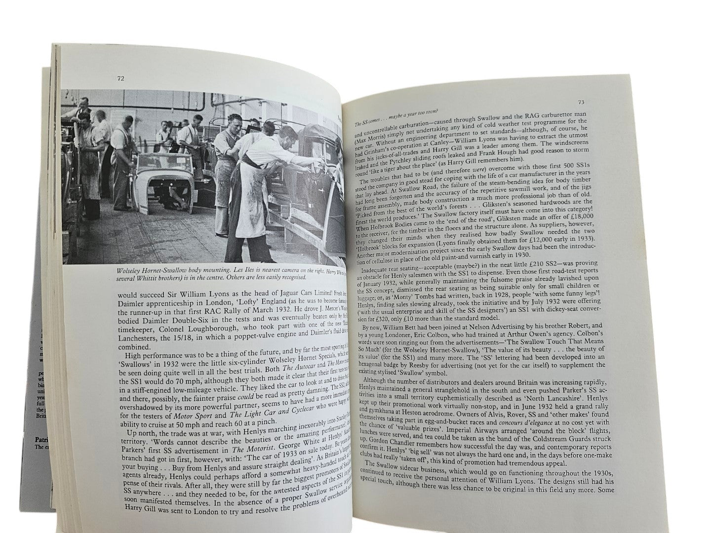 Automoto Bookshop Jaguar history book open to a page showing black and white photos of early car manufacturing