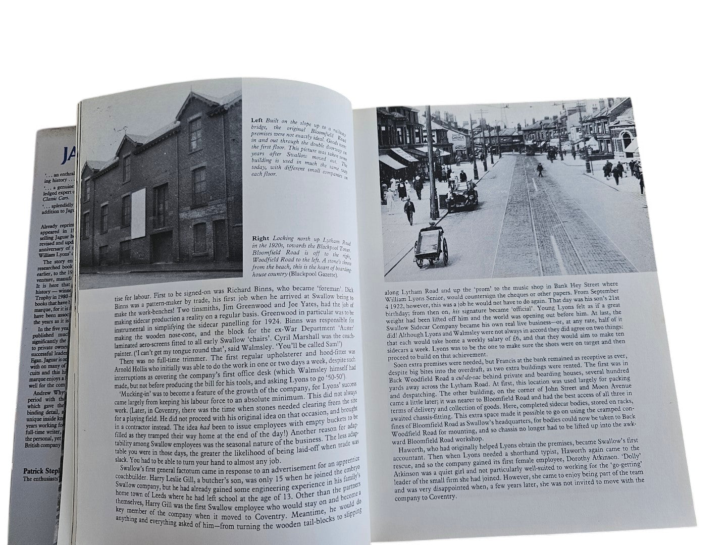 Automoto Bookshop Jaguar The Definitive History book open to pages showing historical black and white photos of buildings