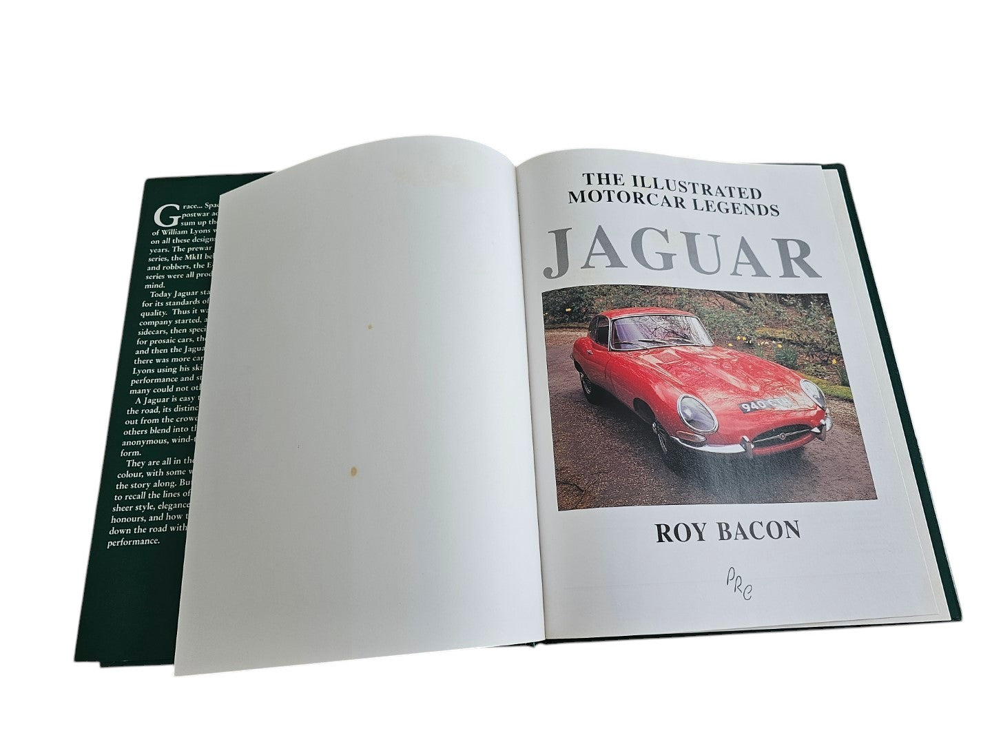 Automoto Bookshop pre-owned Jaguar The Illustrated Motorcar Legends book open to title page with red E-Type photo