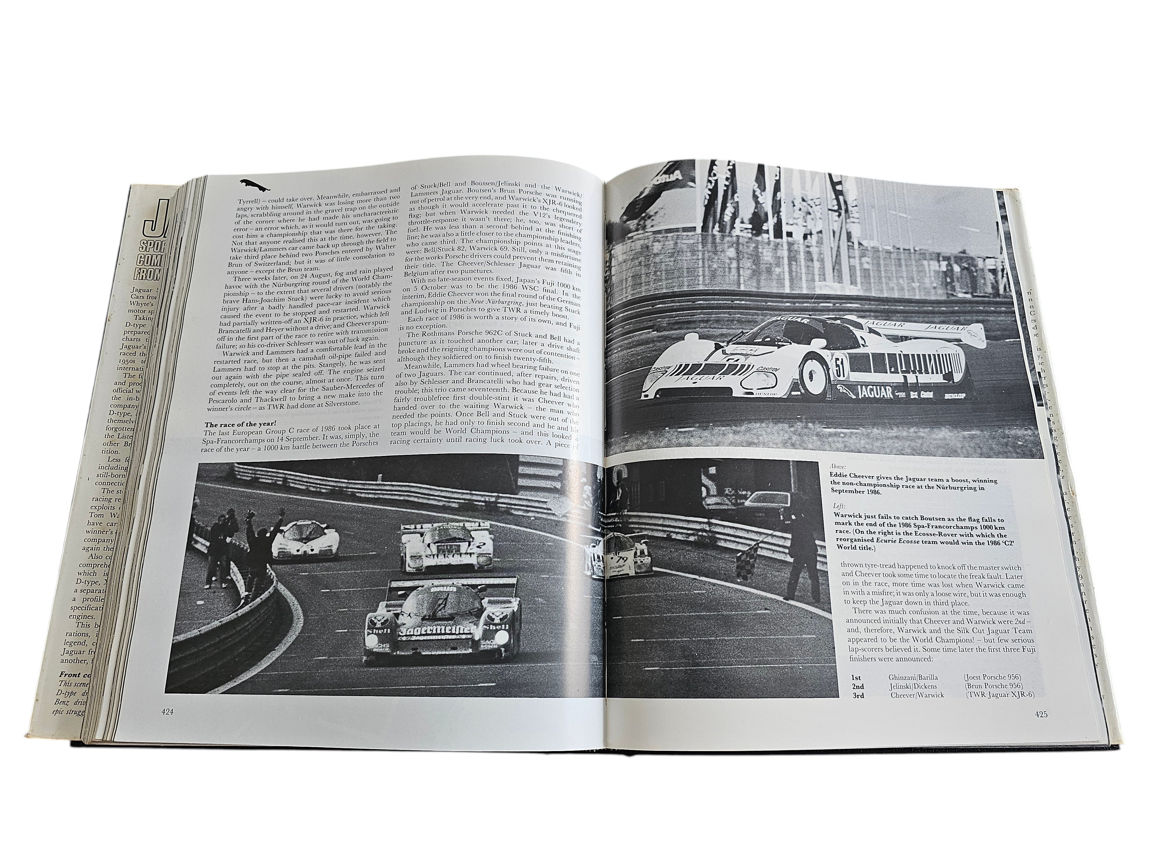 Automoto Bookshop vintage Jaguar racing book open to pages showing black and white photos of Jaguar XJR-6 race cars.
