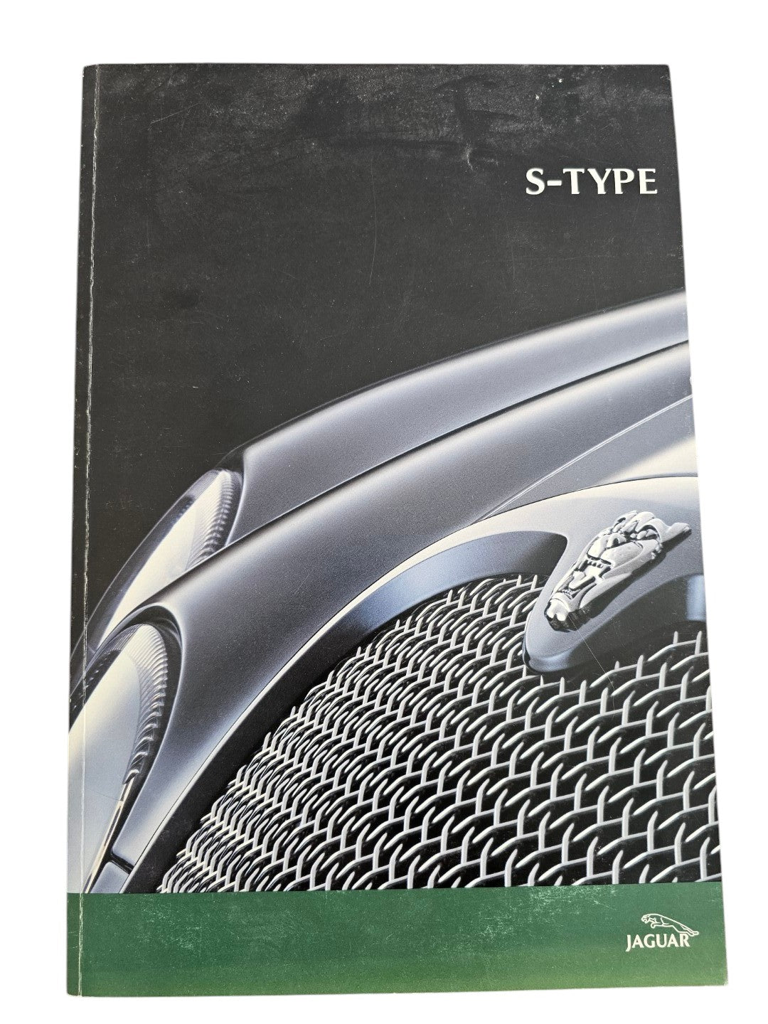 Automoto Bookshop 2002 Jaguar S-Type sales brochure featuring a close-up of the car grille and leaping cat emblem.