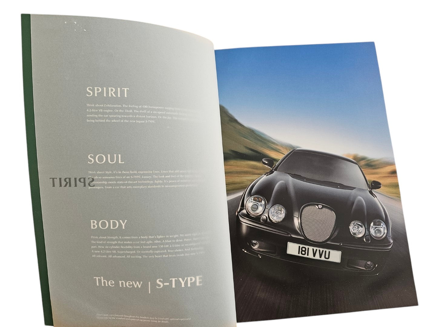 Automoto Bookshop 2002 Jaguar S-Type sales brochure featuring a black sedan on a scenic road with marketing text.