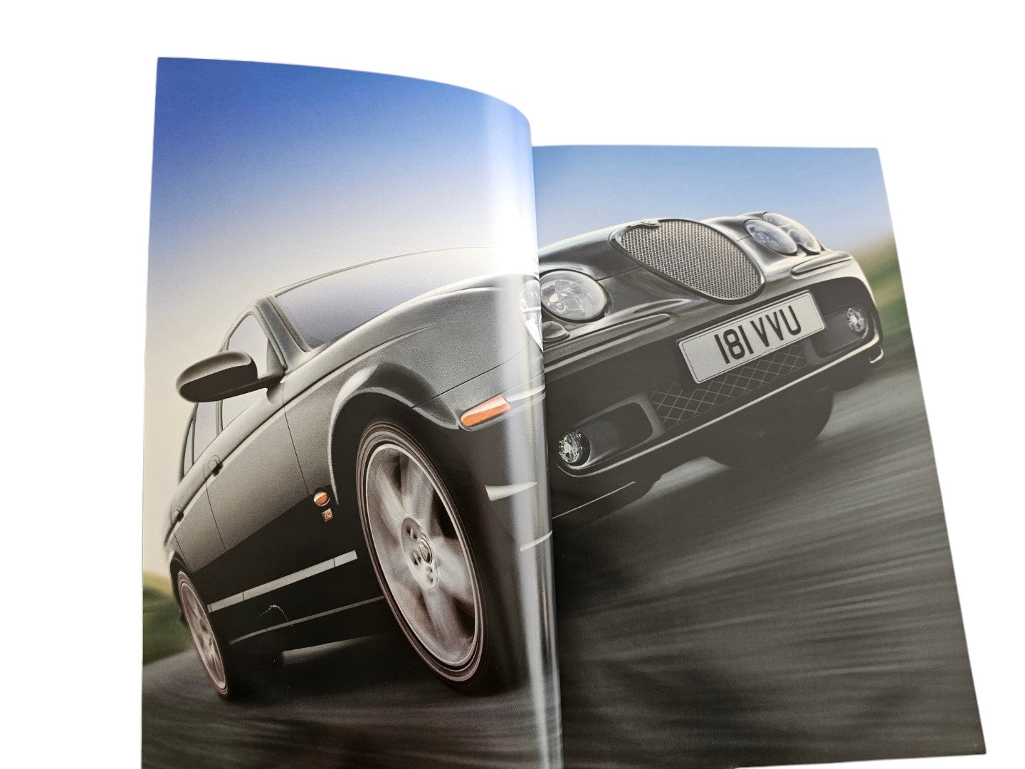 Automoto Bookshop 2002 Jaguar S-Type sales brochure featuring a dynamic studio photograph of a dark sedan in motion.