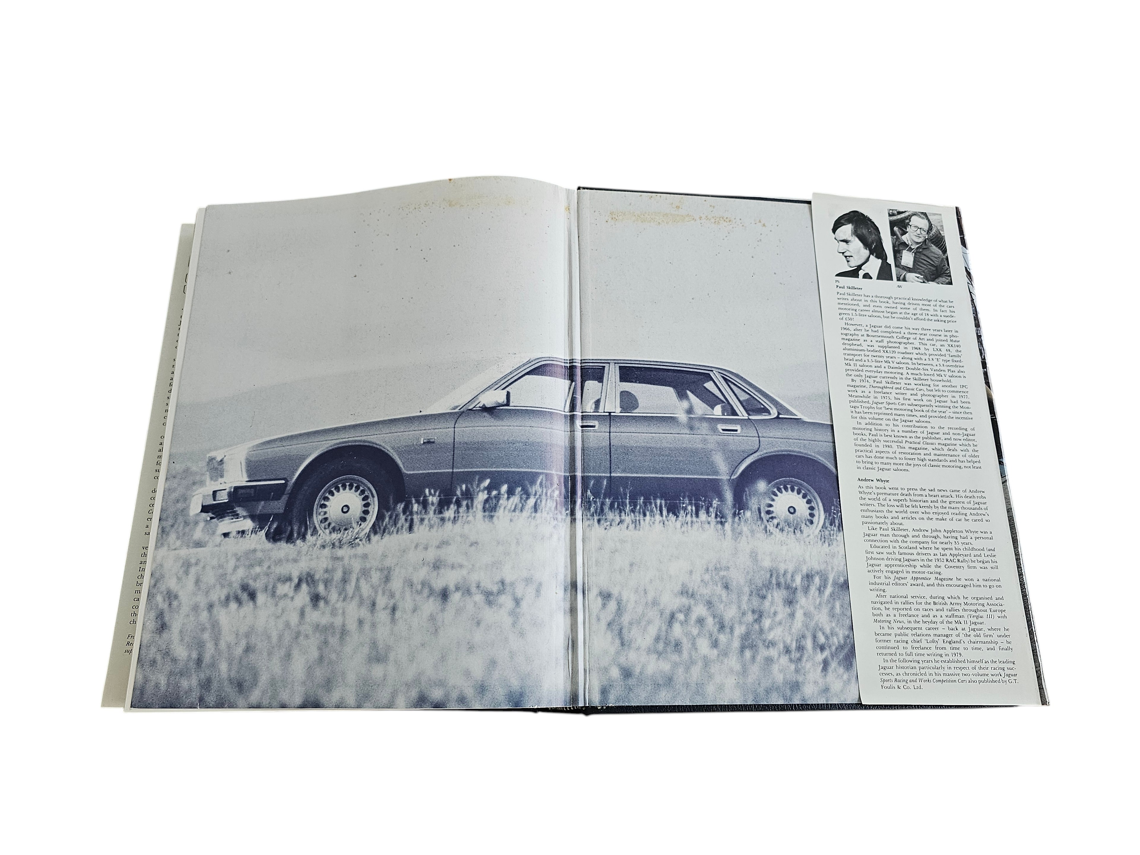 Automoto Bookshop 1988 Jaguar Saloon Cars hardcover book open to a page featuring a classic Jaguar car photograph