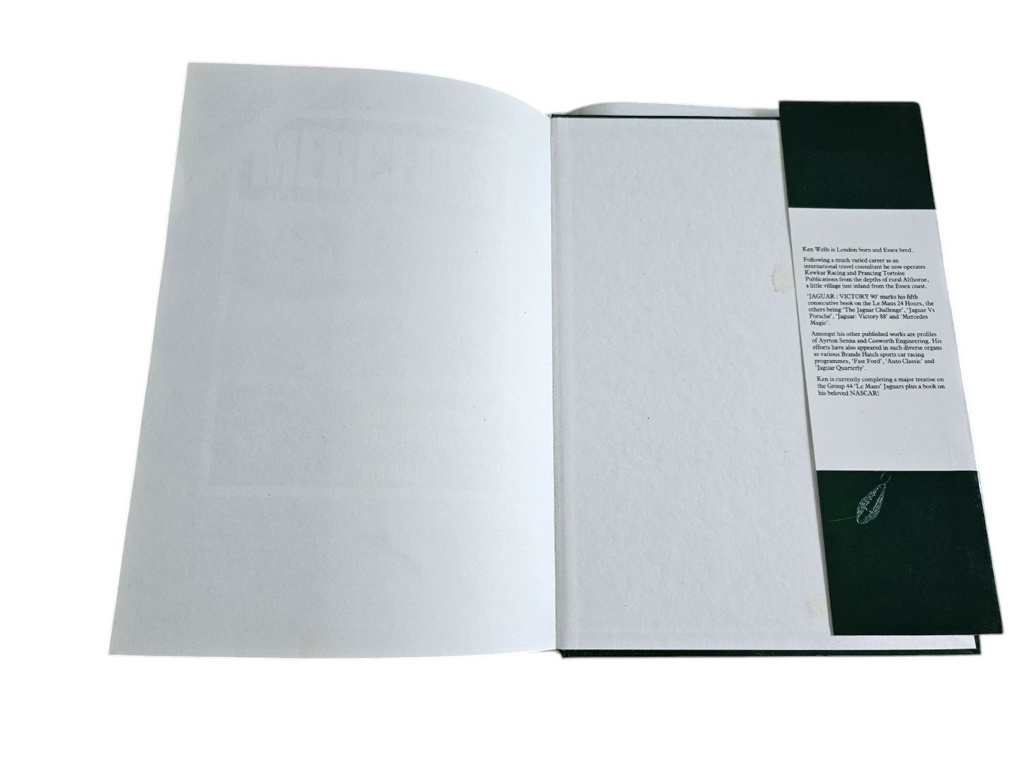 Automoto Bookshop hardcover copy of Jaguar Victory '90 by Ken Wells, showing the inside dust jacket flap