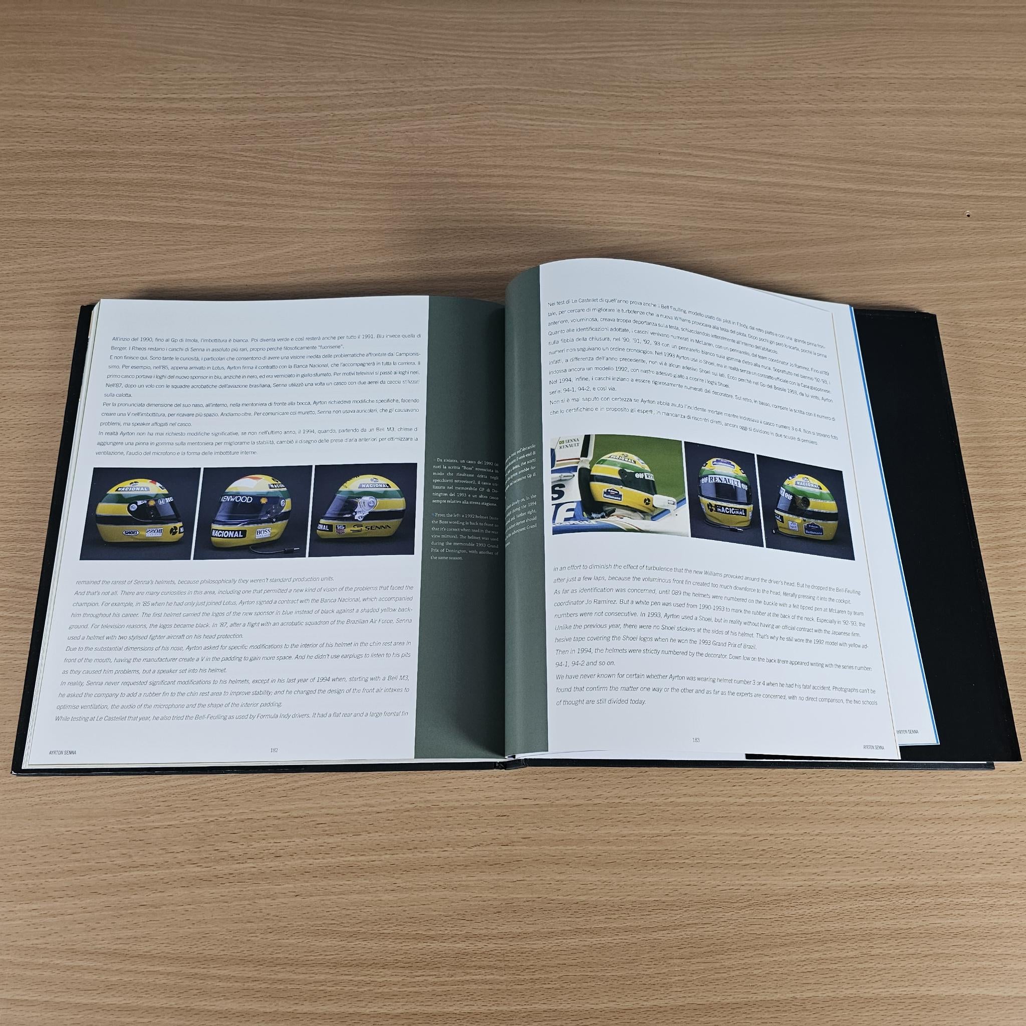 Open hardcover photo book with photo captions, charts, and printed paragraphs