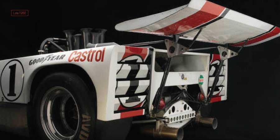 Racing book photo of white race car with number 1 and open rear body