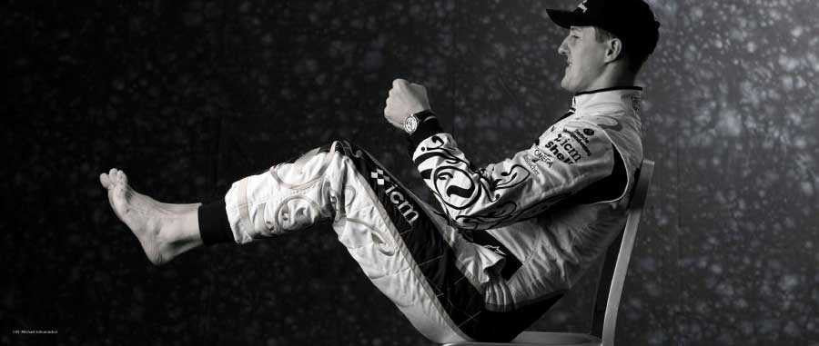 Signed photo book open to racing driver in suit with raised arms