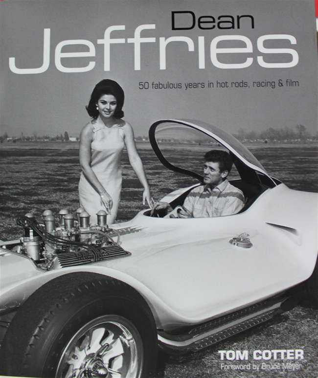 Front cover book showing Dean Jeffries logo, woman and driver in classic hot rod