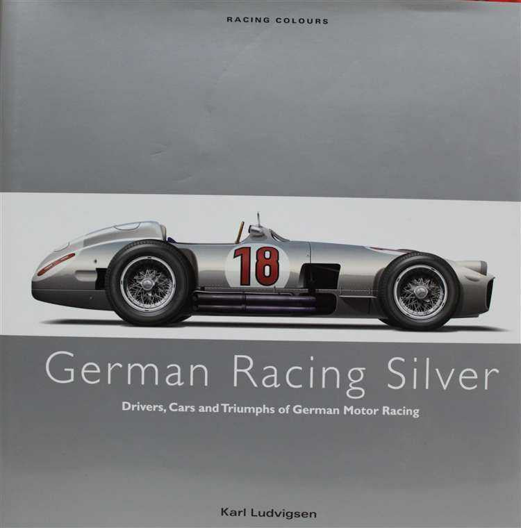 Racing history book cover with silver race car, red number 18, and title lettering