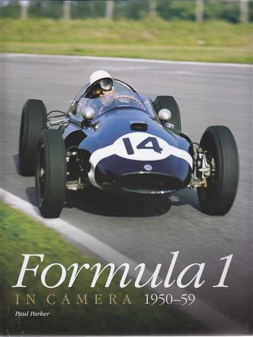 Formula 1 photo book cover with blue race car on track and title text