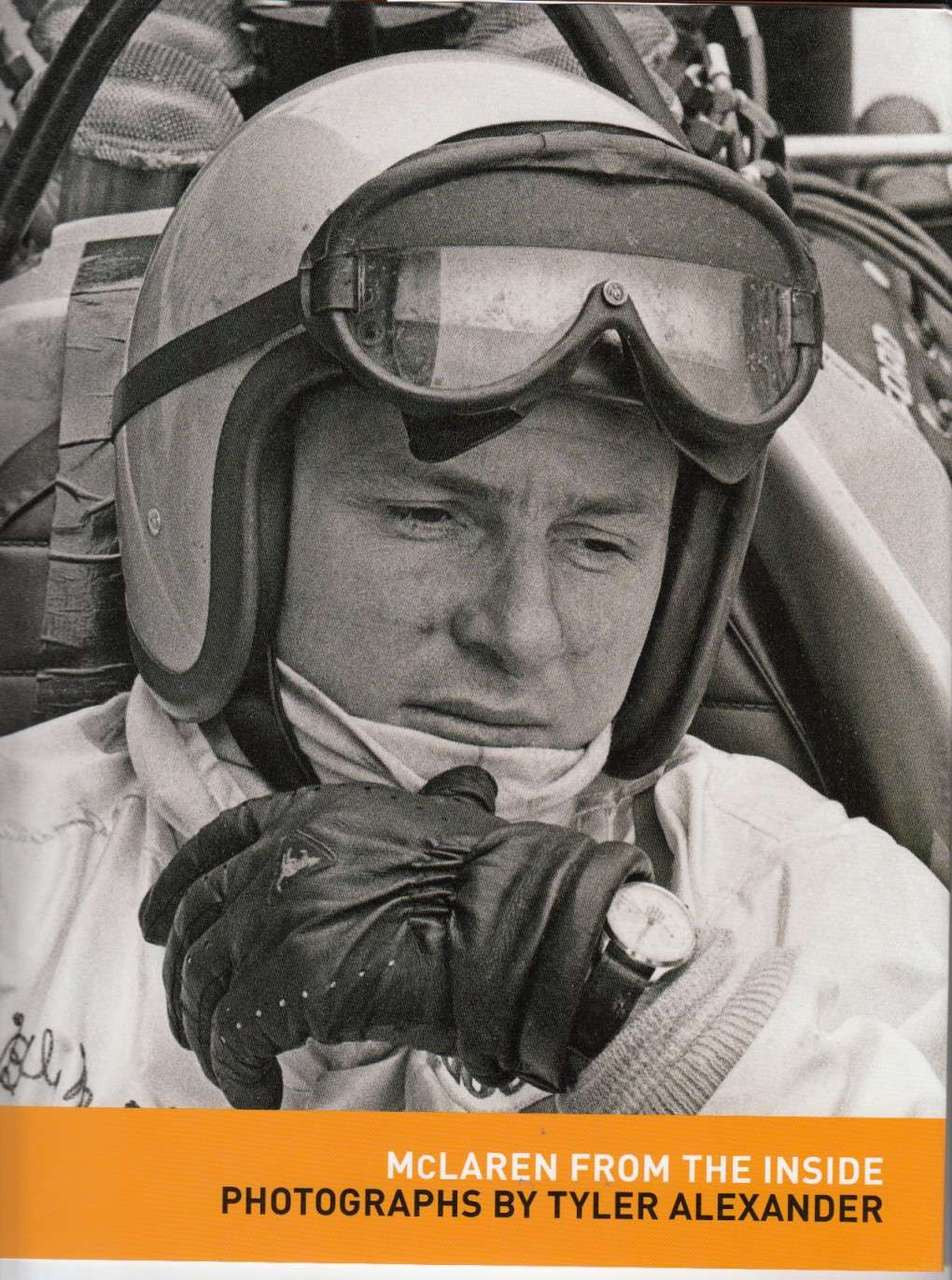 Motorsport photo book cover with pilot portrait and orange title strip, goggles