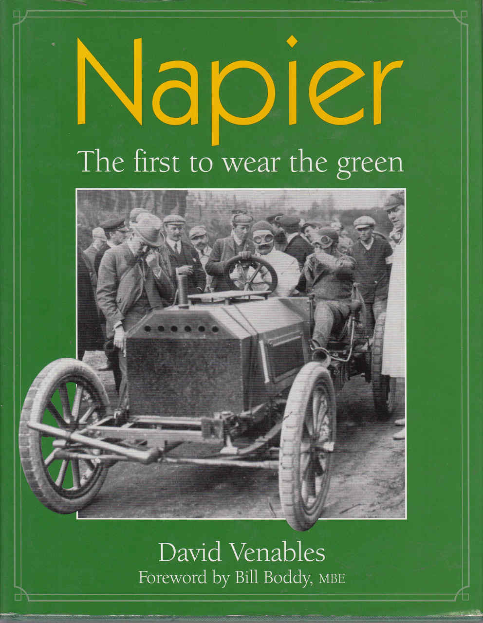 Green paperback book cover with vintage race car photo and title text.