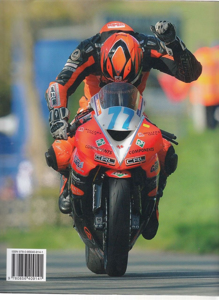 Motorcycle road racer in red and black suit, helmet and gloves on track.