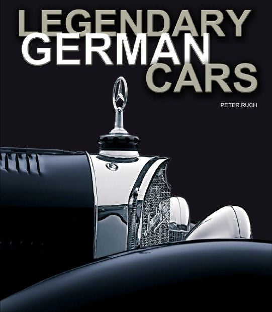 Classic car hood ornament on dark blue vehicle, chrome grille and fender detail