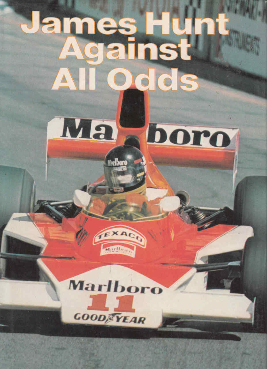 Signed racing memoir book cover with James Hunt title and orange race car image