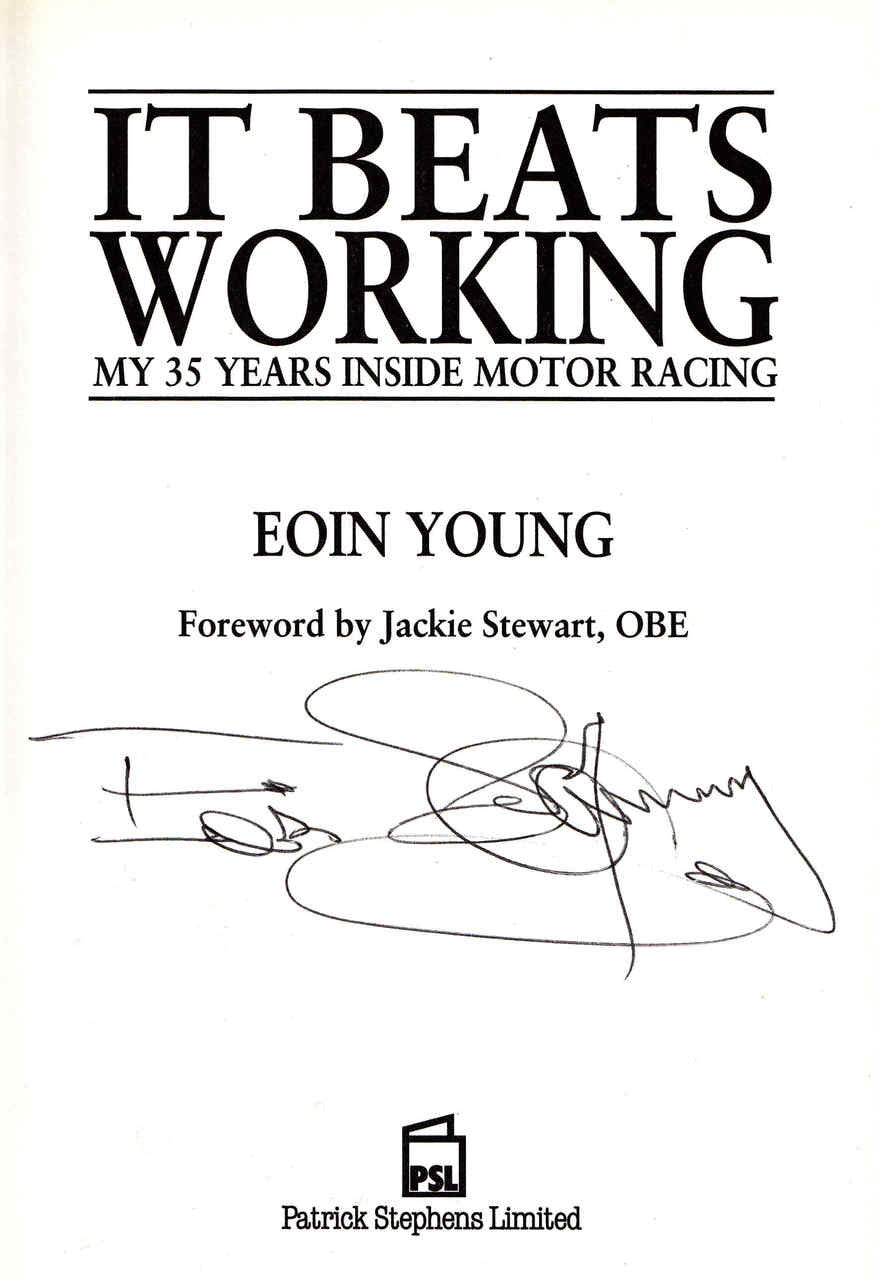 Autographed motor racing memoir book cover with title text and author signature