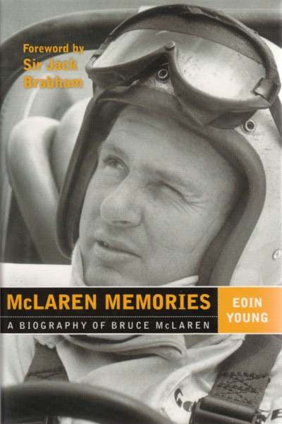 Signed motorsport biography book, driver portrait on helmeted cover with bold title