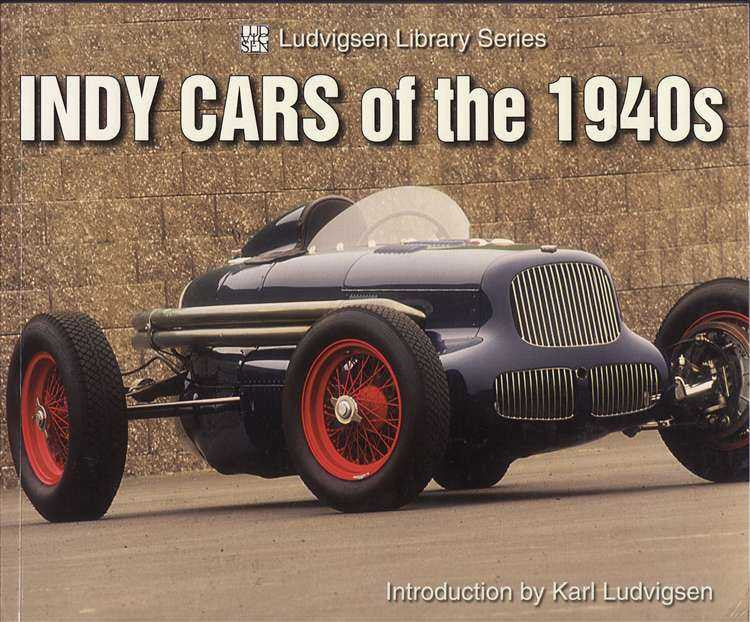 Race car history book cover with blue vintage Indy car and red wheel rims