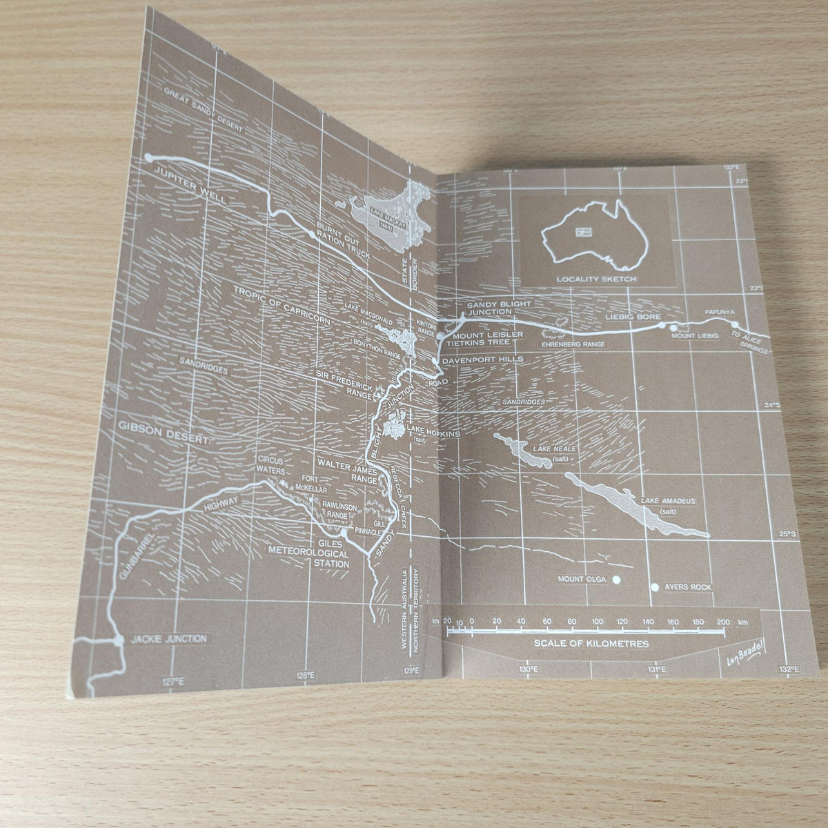 Open book page with gray vintage-style map graphic and route labels