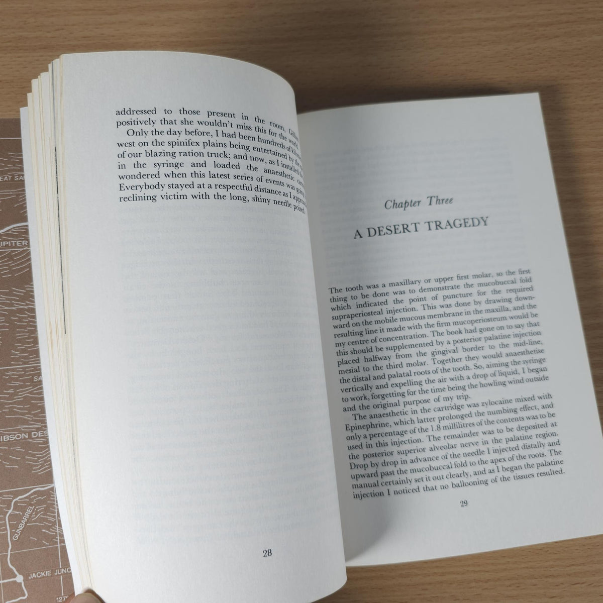 Open book page with chapter heading 'A Desert Tragedy' and descriptive paragraphs