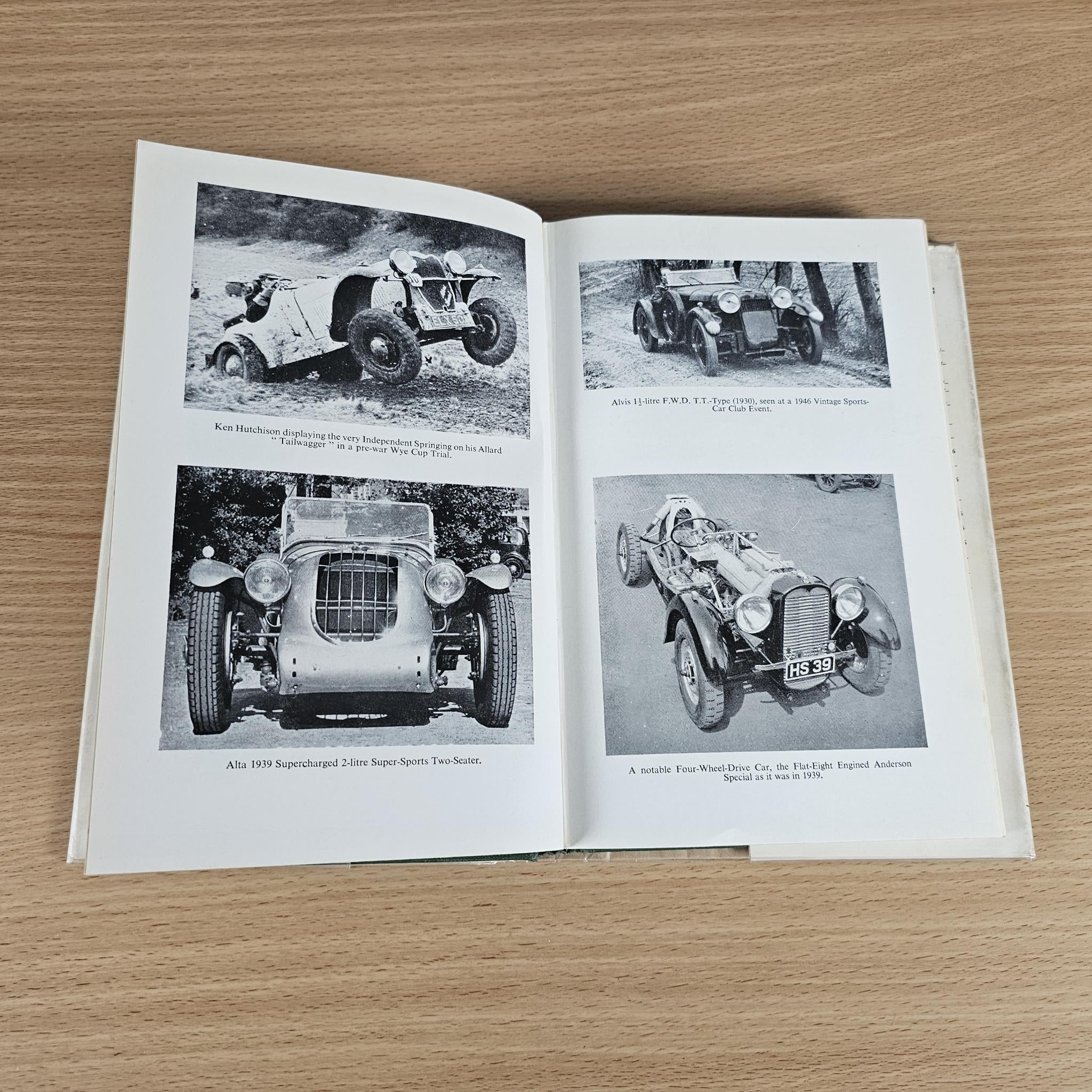 Open book showing black-and-white vintage sports car photos on two pages