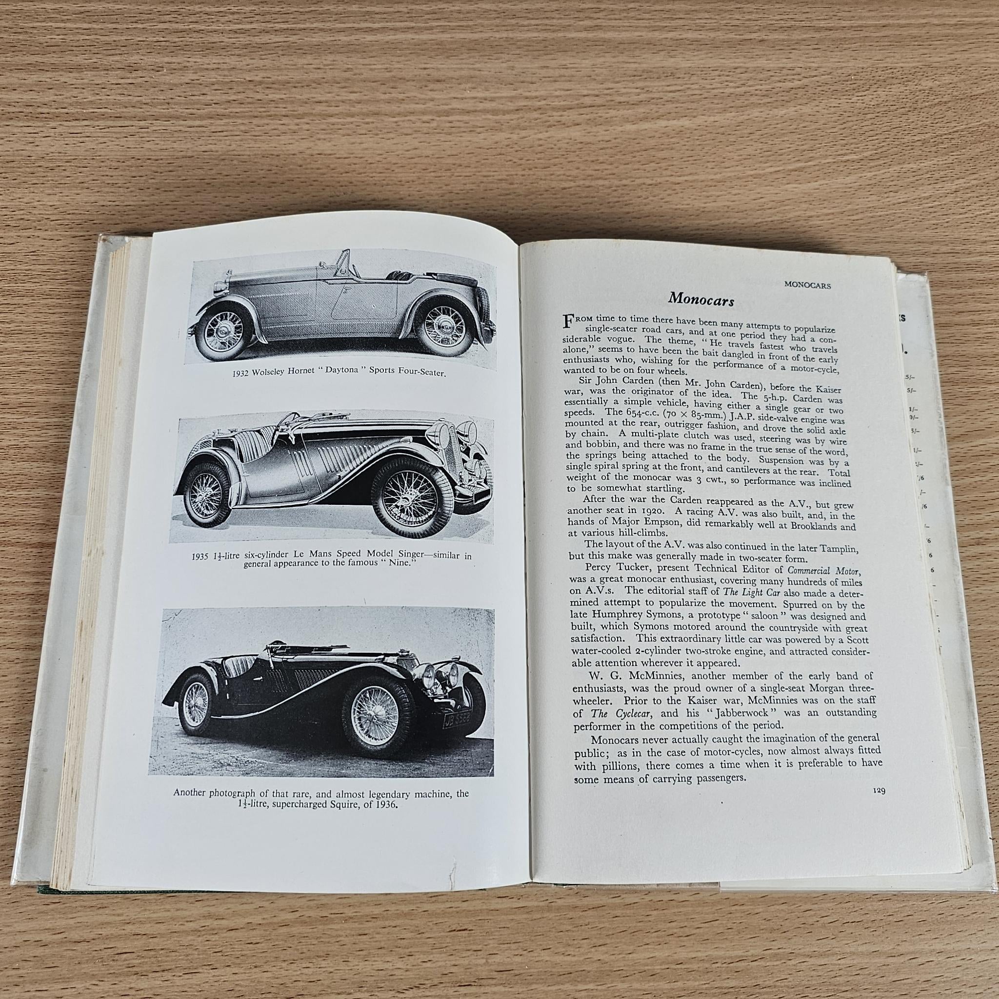 Open book showing black-and-white classic sports car images and diagrams