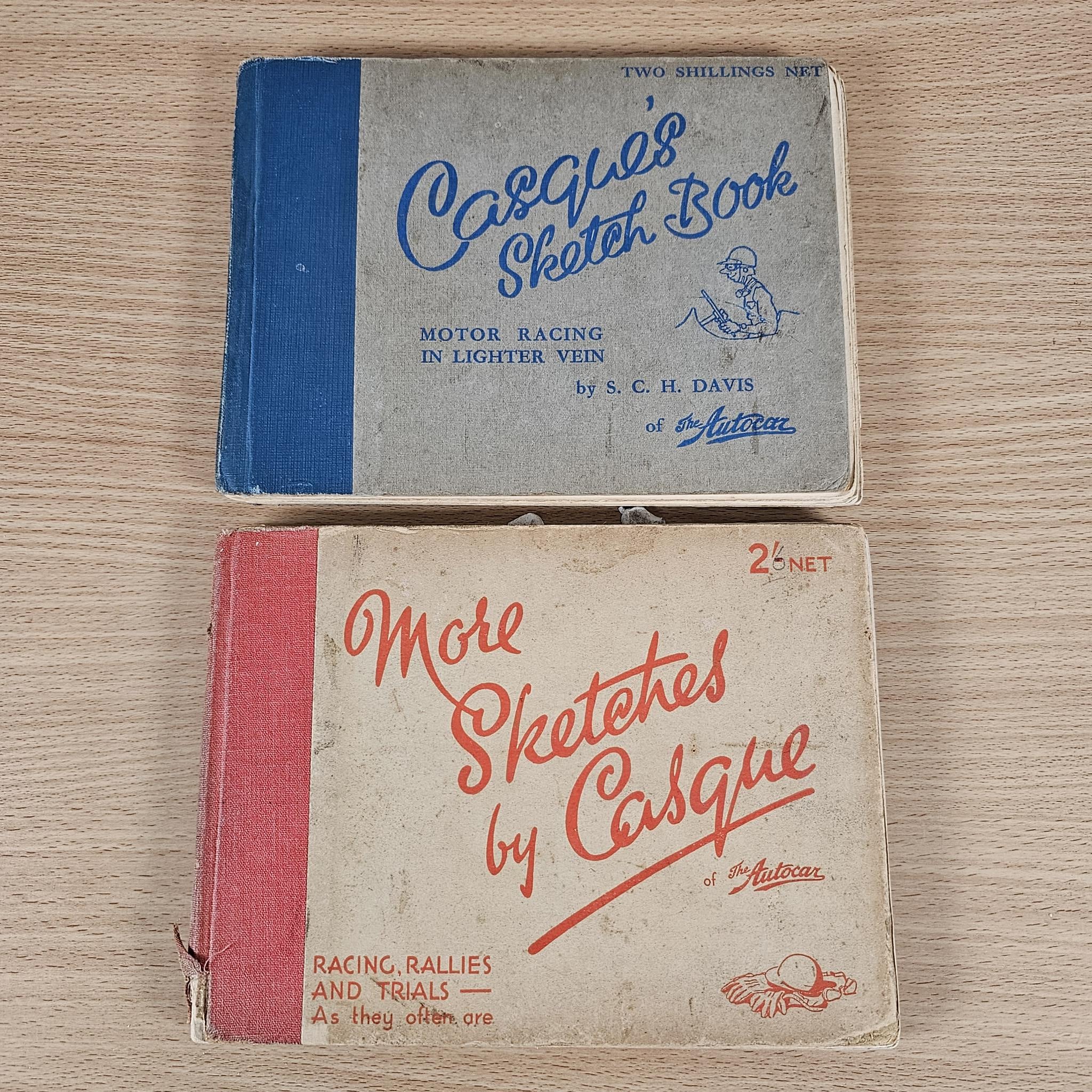 Set of two vintage sketch books on wood table, blue and red printed covers