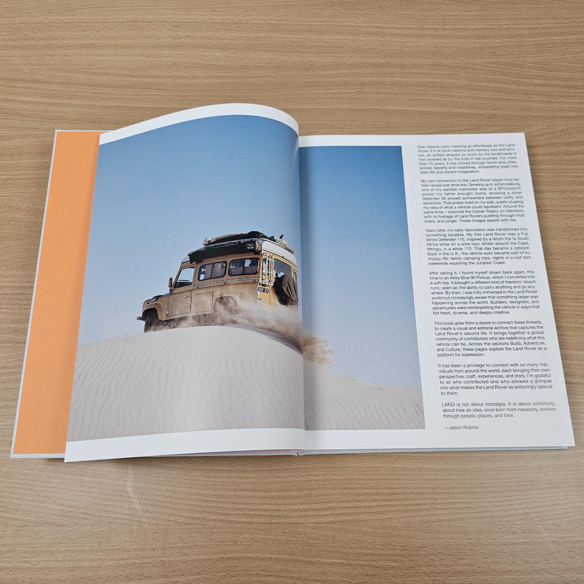 Open Land Rover book with dune photo on left and paragraph text on right