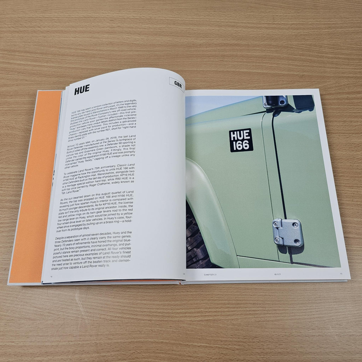 Open Land Rover book with “HUE” heading and vehicle close-up photo
