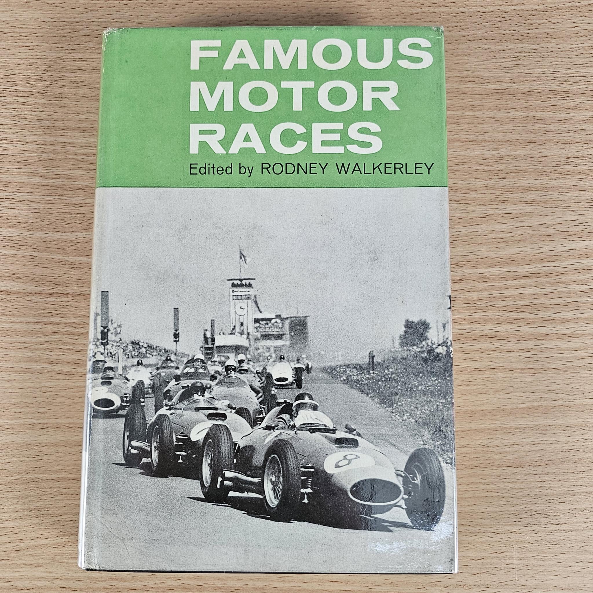 Vintage book front cover on wood: green top panel with “Famous Motor Races”