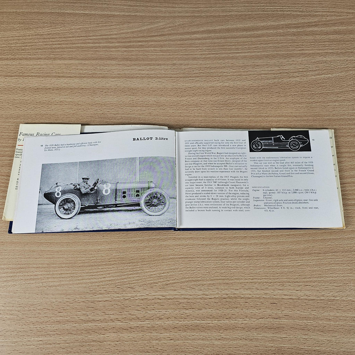 Vintage racing cars book, open spread with classic car photo and description text.