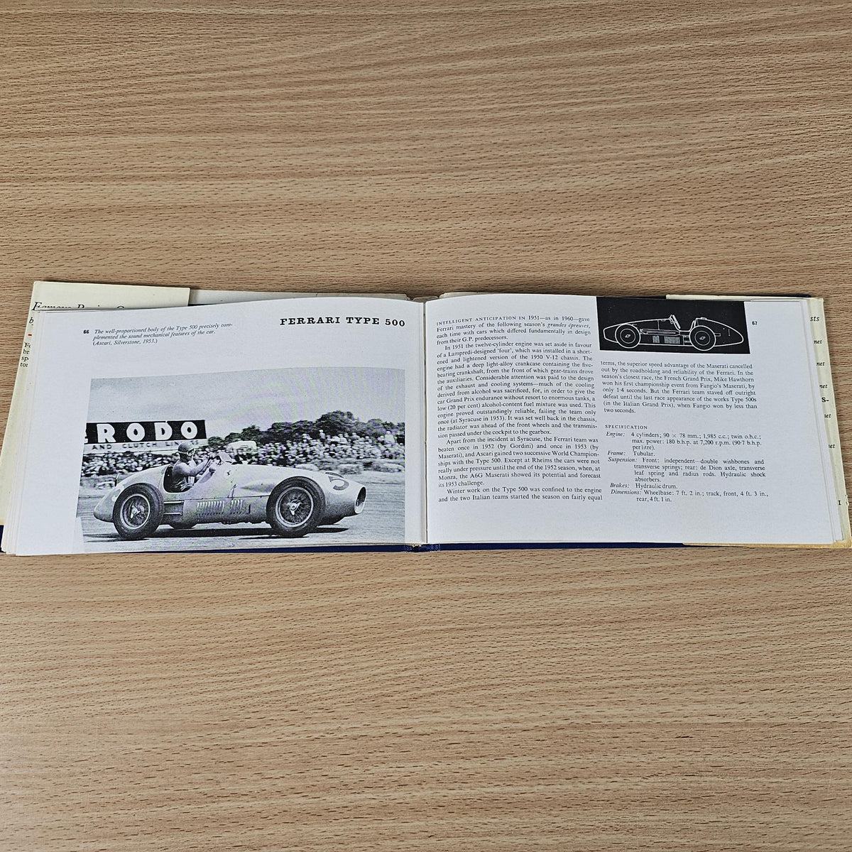 Vintage racing cars book, open spread with classic Ferrari photo and technical text.