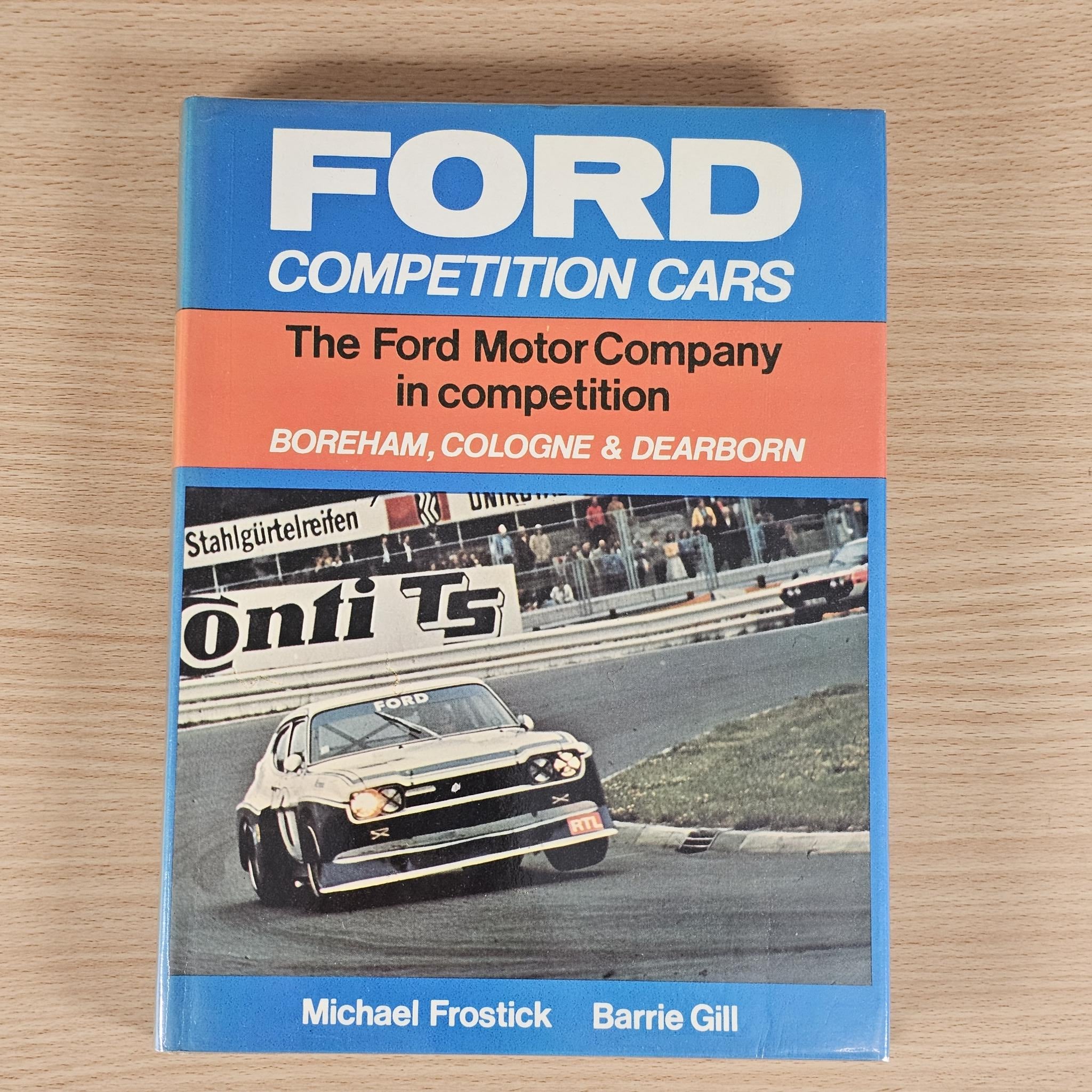 Ford Competition Cars paperback cover with blue 'FORD' logo and race-car image.