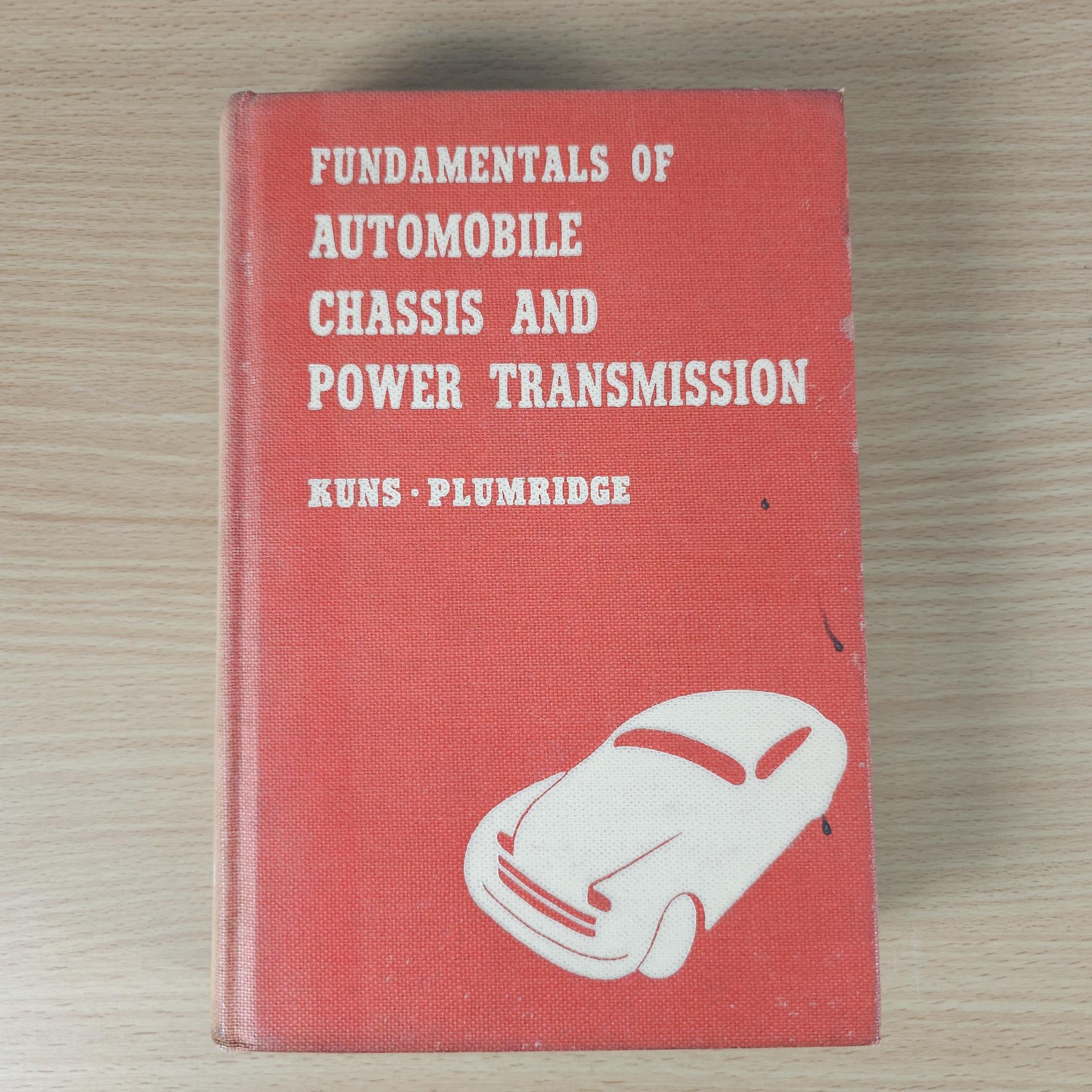 Red hardcover engineering book with white car graphic on front cover