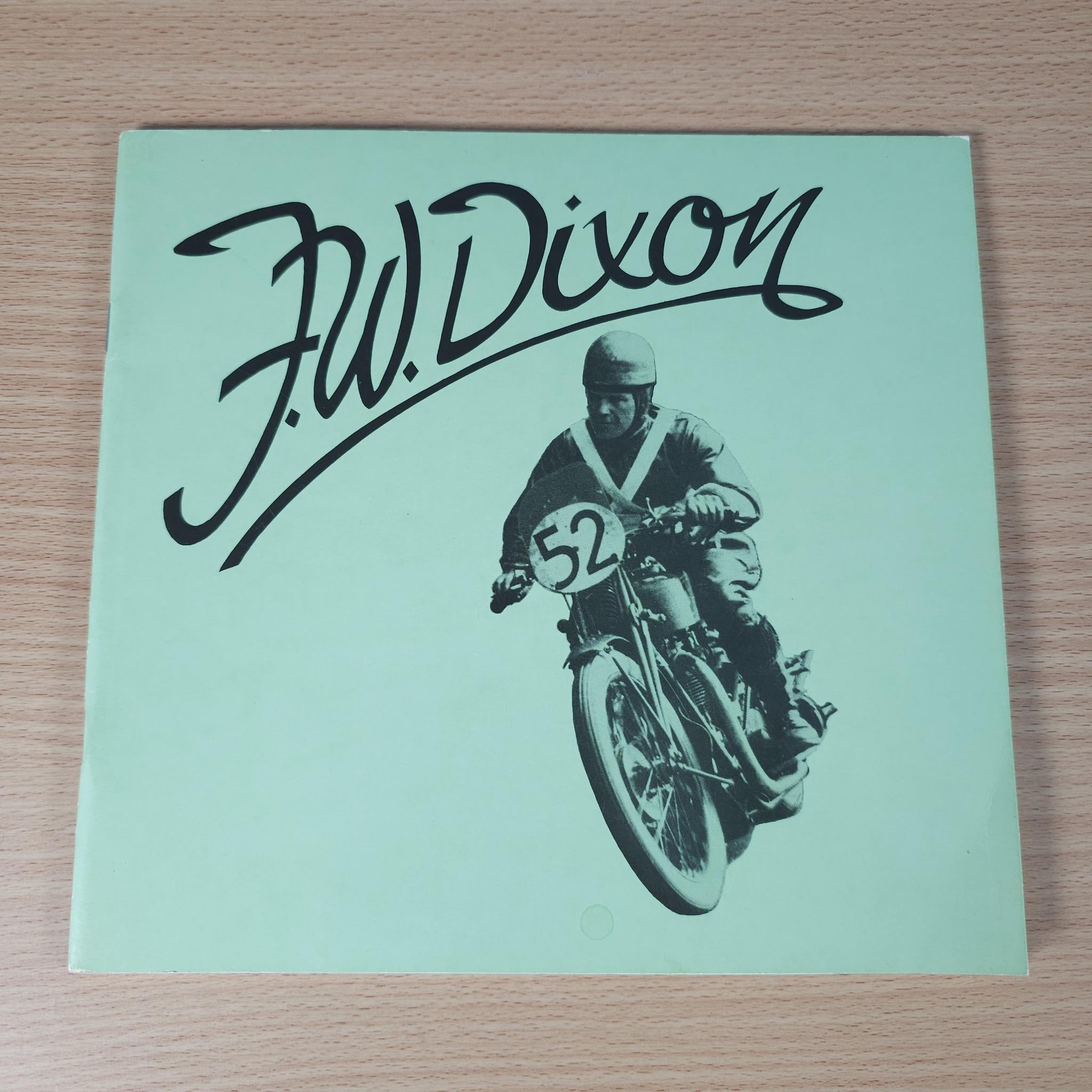 Vintage motorcycle book cover, mint green with Dixon script and rider on bike number 52