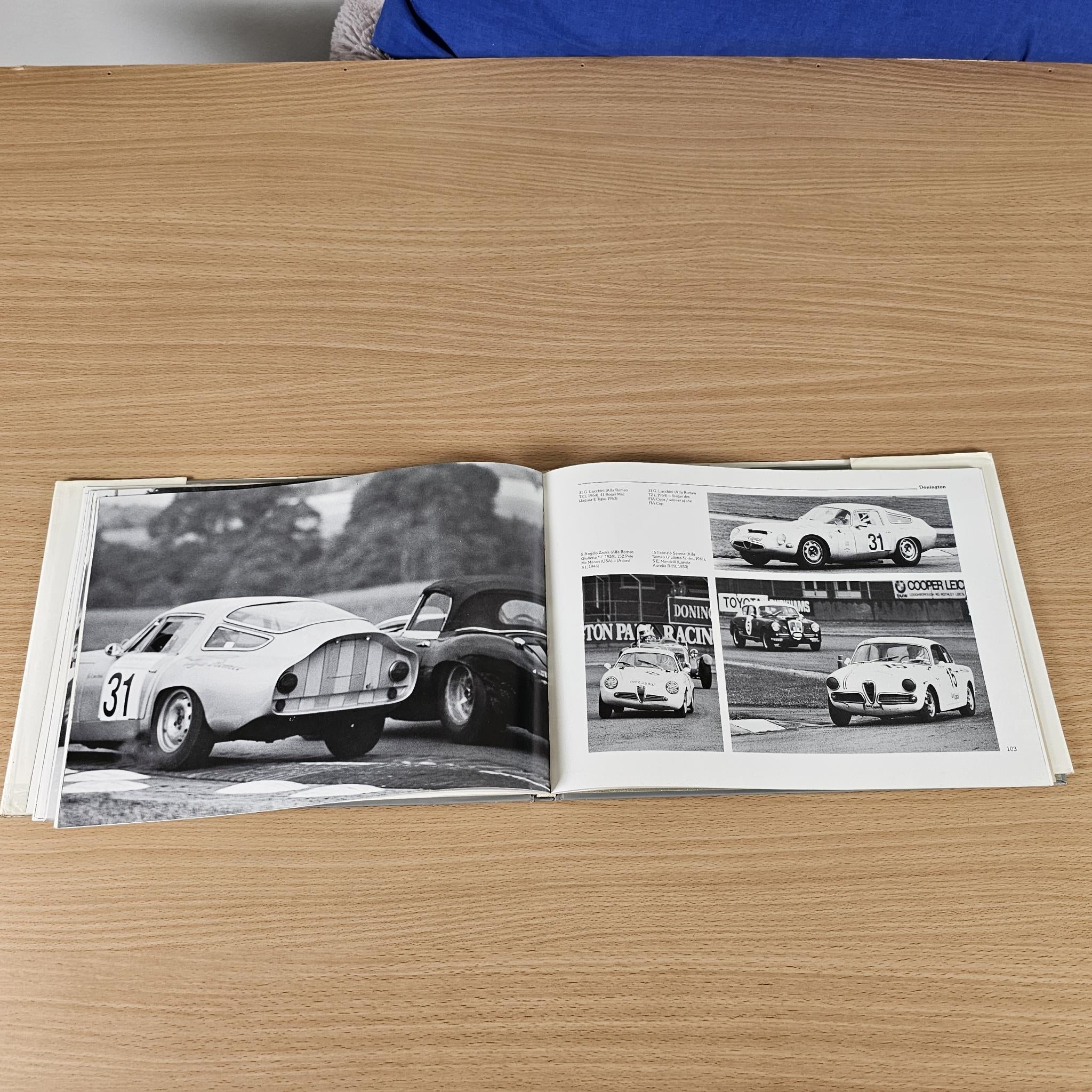 Car racing book photo spread with black-and-white white race car and action shots