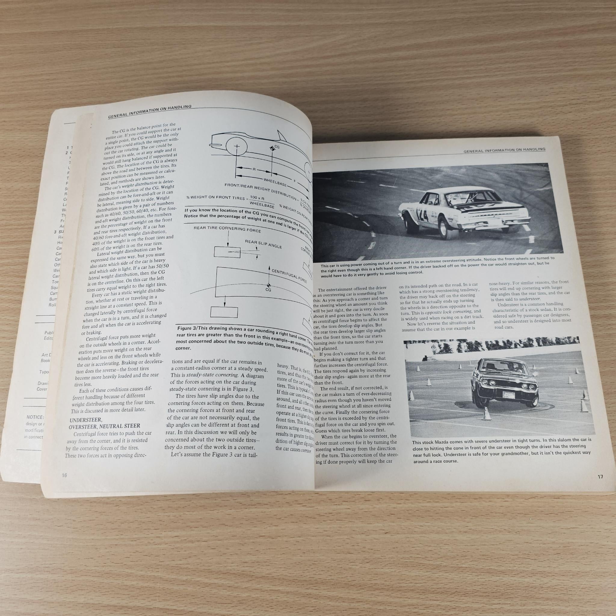 Open car handling guidebook with technical diagrams and grayscale race car illustrations