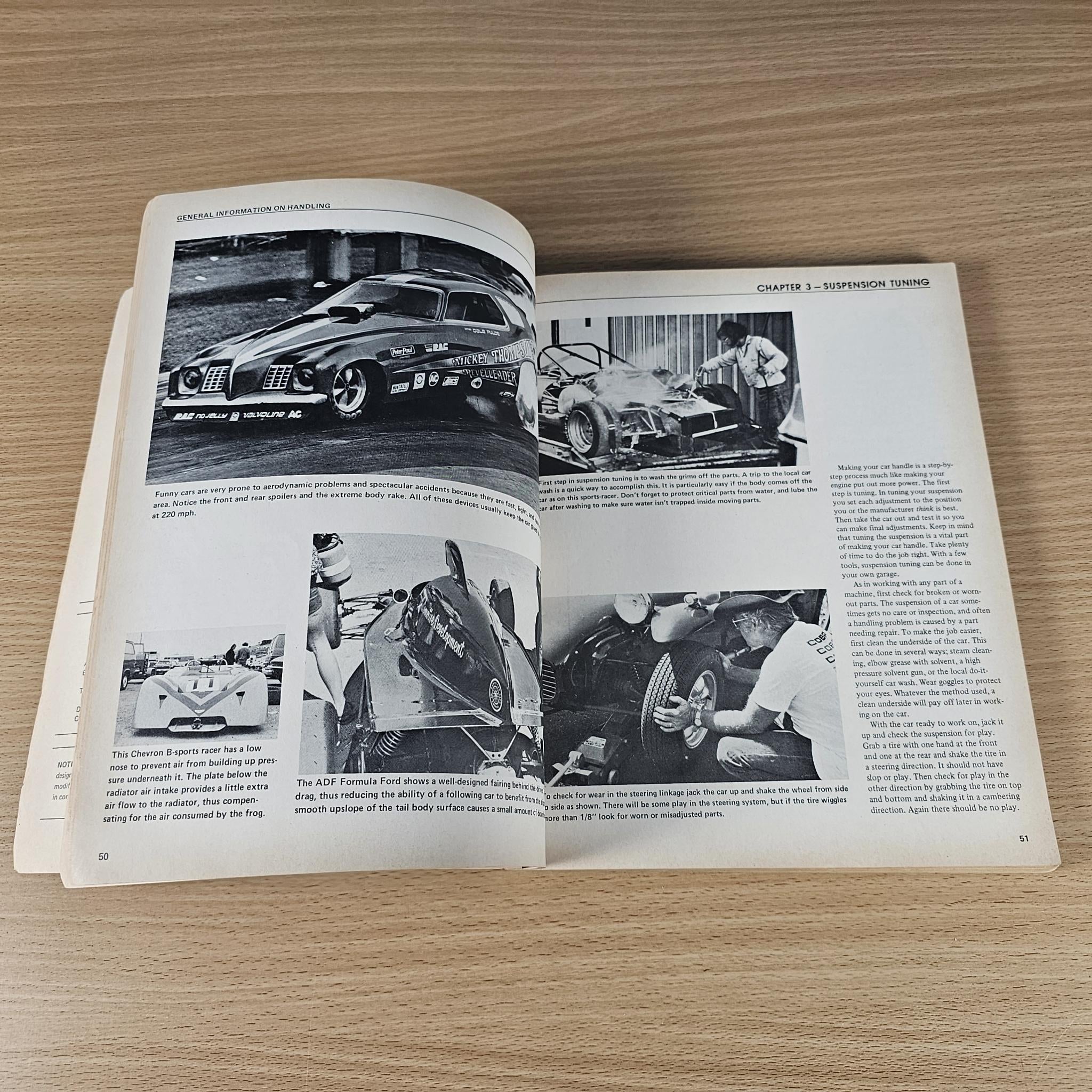 Open car handling guidebook showing grayscale photos and chapter text on facing pages